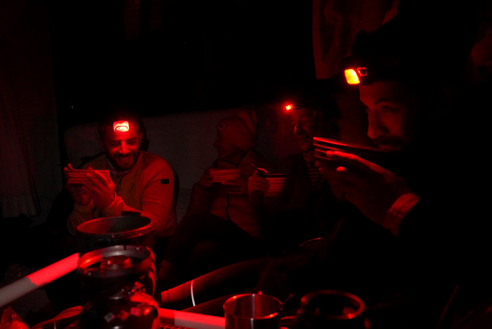 Repas à la frontale dans la cabane pendant la traversée à ski des Alpes ligures, au jour 3 de l’itinérance.