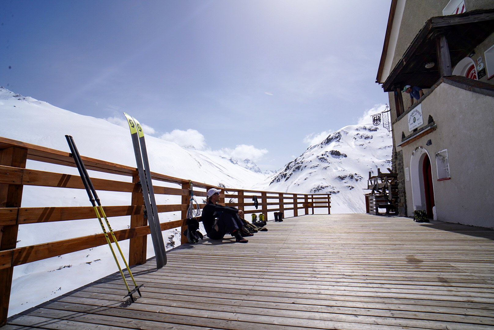 Skis posés sur la terrasse du refuge face aux montagnes, étape Martin-Busch-Hütte – Hochjoch Hospiz, dans les Alpes de l’Ötztal en Autriche.