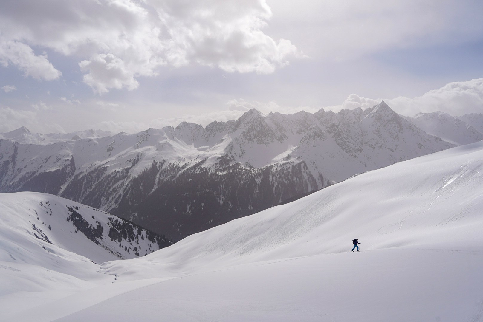Skieur solitaire au-dessus des vallées pendant le tour à ski du Verwall au Tyrol, au jour 2 de l’itinérance.